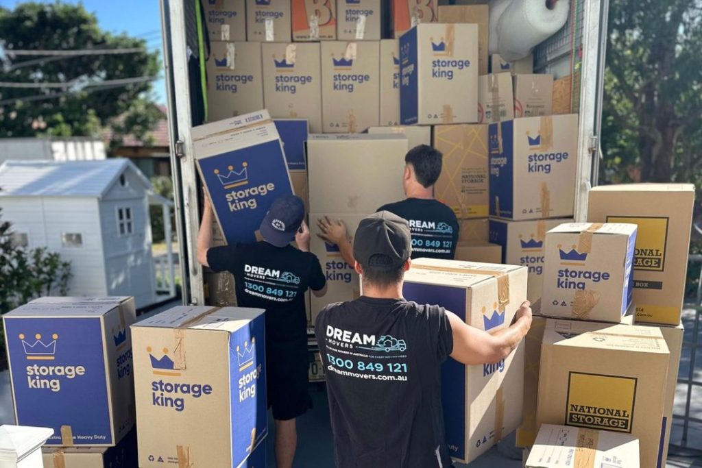Dream Movers crew loading boxes into a truck when moving a 2 bedroom apartment
